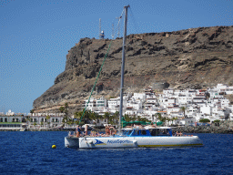 Boat in front of the town center with the Hotel THe Puerto de Mogán, viewed from the Sagitarius Cat boat