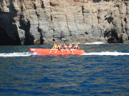 Banana boat in front of the coastline just east of the town, viewed from the Sagitarius Cat boat