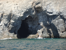 Small boat in front of a cave at the coastline just east of the town, viewed from the Sagitarius Cat boat
