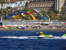 Jet skis in front of the Lago Taurito Water Park at the Playa del Diablito beach, viewed from the Sagitarius Cat boat