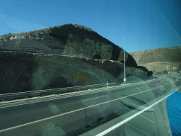 Tunnels at the GC-1 road just east of the town of Arguineguín, viewed from the tour bus bus from Maspalomas