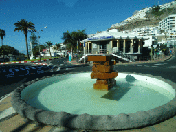 Fountain in front of the Tourist Office at the Avenida de Mogán street, viewed from the tour bus bus from Maspalomas