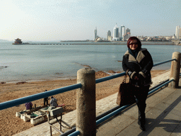 Miaomiao with the beach, Zhan Qiao pier, Qingdao Bay and skyscrapers at the west side of the city
