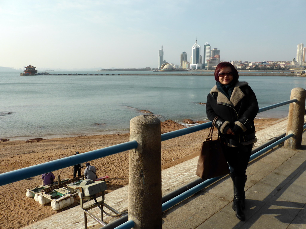 Miaomiao with the beach, Zhan Qiao pier, Qingdao Bay and skyscrapers at the west side of the city