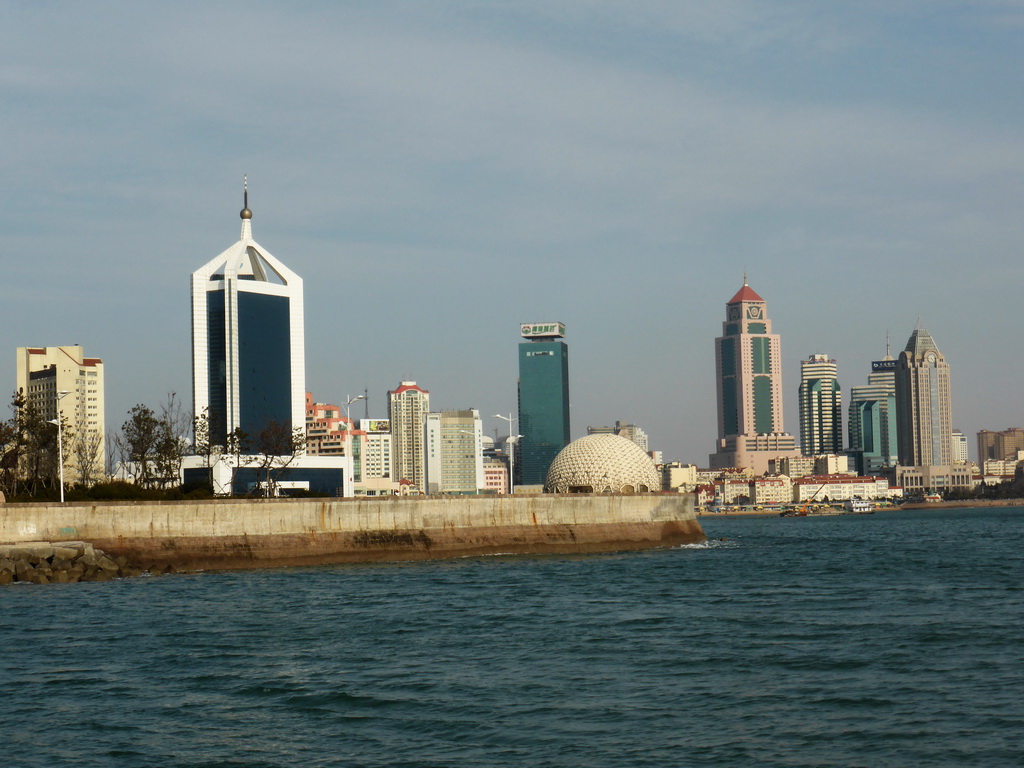 Qingdao Bay and skyscrapers and dome at the west side of the city and skyscrapers at the city center, viewed from the tour boat