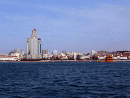 Qingdao Bay, Zhan Qiao pier, the beach at Taiping Road, skyscrapers at the city center and St. Michael`s Cathedral, viewed from the tour boat