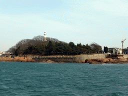 Xiao Qingdao island with its lighthouse and pavilion in Qingdao Bay, viewed from the tour boat