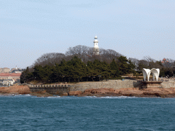 Xiao Qingdao island with its lighthouse and pavilion in Qingdao Bay, viewed from the tour boat