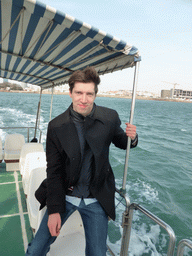 Tim on the tour boat, with a view on Qingdao Bay and the city center