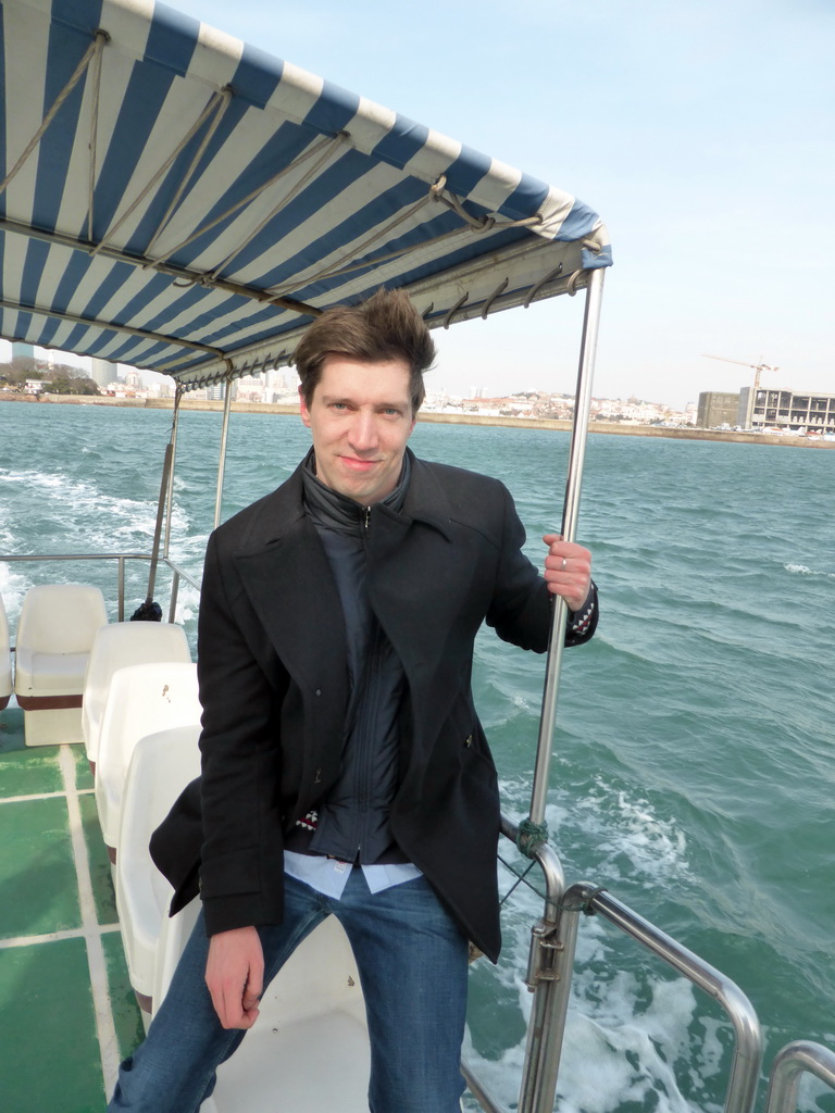 Tim on the tour boat, with a view on Qingdao Bay and the city center