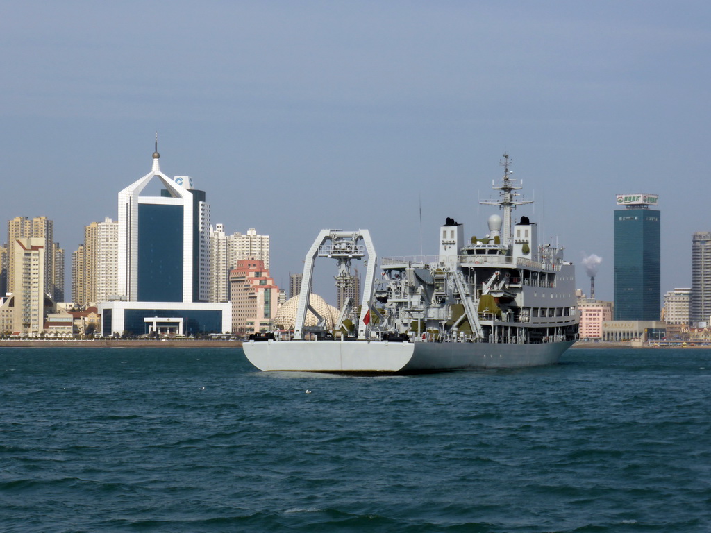 Boat in Qingdao Bay and skyscrapers and dome at the west side of the city, viewed from the tour boat