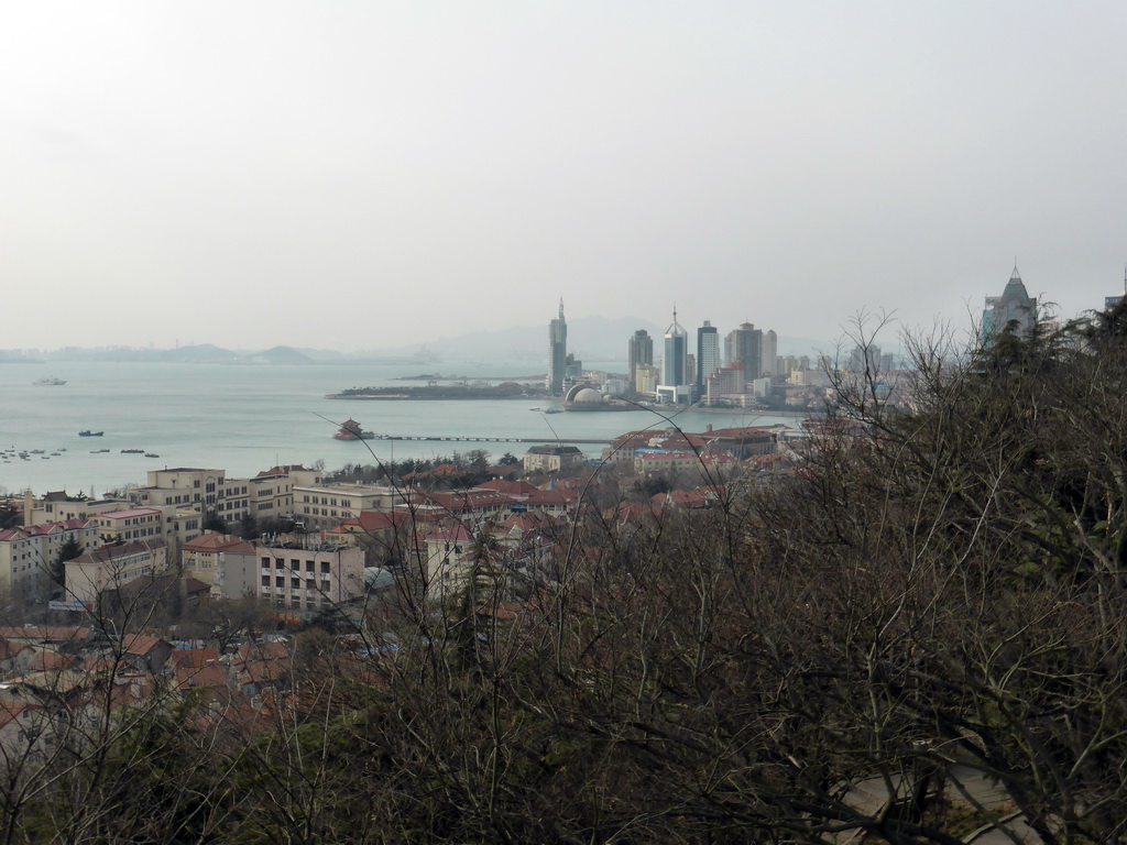 The skyscrapers and dome at the west side of the city, the Zhan Qiao pier, the Qingdao bay and the city center, viewed from the viewing point at the Xinhaoshan Park