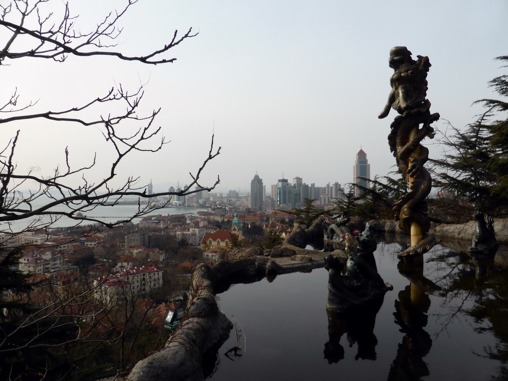 The Jade Dragon Pool at the Xinhaoshan Park, with a view on the skyscrapers at the city center and the Zhan Qiao pier in Qingdao Bay