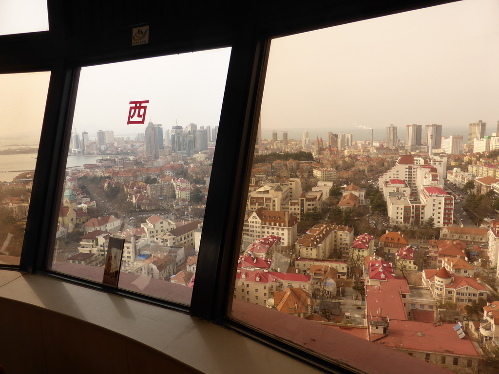 The city center with skyscrapers, St. Michael`s Cathedral and the Qingdao Protestant Church and Qingdao Bay, viewed from the rotating sightseeing tower at the Xinhaoshan Park