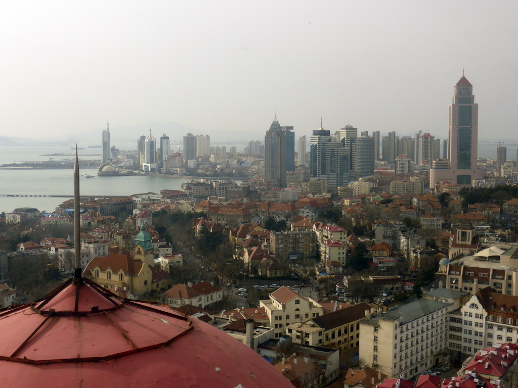 The city center with skyscrapers and the Qingdao Protestant Church, Qingdao Bay and the skyscrapers and dome at the west side of the city, viewed from the rotating sightseeing tower at the Xinhaoshan Park