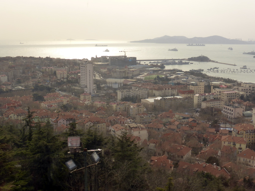 The city center with the Qingdao Naval Museum, Qingdao Bay with Xiao Qingdao island and the Huangdao district, viewed from the rotating sightseeing tower at the Xinhaoshan Park