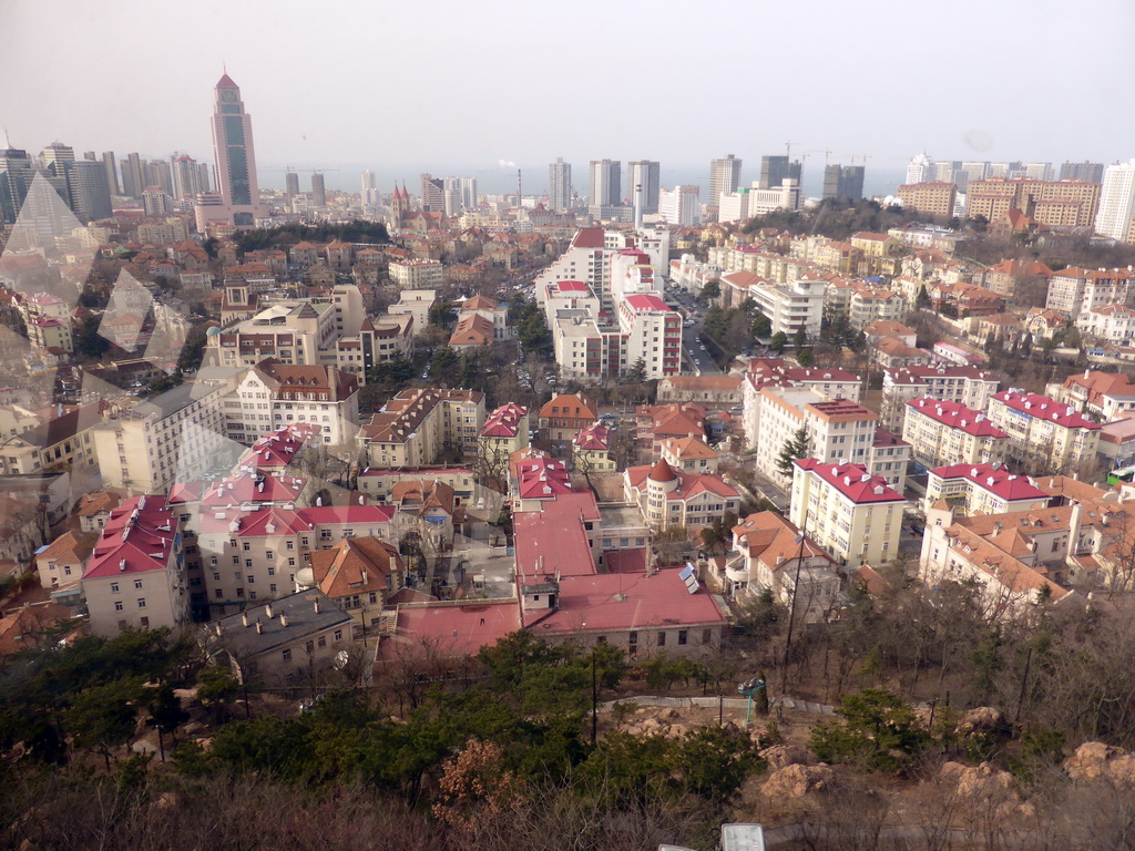 The city center with skyscrapers, St. Michael`s Cathedral and the Quanxiangshan Park, viewed from the rotating sightseeing tower at the Xinhaoshan Park