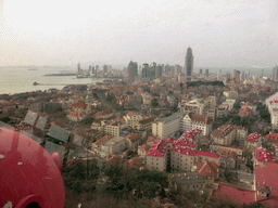 The city center with skyscrapers, St. Michael`s Cathedral and the Qingdao Protestant Church, Qingdao Bay with the Zhan Qiao Pier and the skyscrapers and dome at the west side of the city, viewed from the rotating sightseeing tower at the Xinhaoshan Park