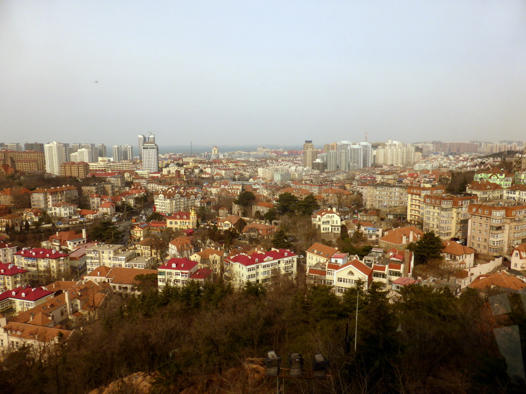 The north side of the city with the Guanxiangshan Park, the Zhushui mountain and the Jiaozhou Bay, viewed from the rotating sightseeing tower at the Xinhaoshan Park