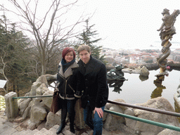 Tim and Miaomiao at the Jade Dragon Pool at the Xinhaoshan Park, with a view on the city center and Zhan Qiao pier in Qingdao Bay