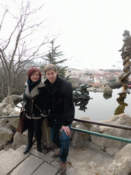 Tim and Miaomiao at the Jade Dragon Pool at the Xinhaoshan Park, with a view on the city center and Zhan Qiao pier in Qingdao Bay