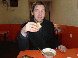 Tim with a donkey meat sandwich in a donkey meat restaurant at Hubei Road