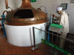 Brew kettle and a wax statue, at the Tsingtao Beer Museum