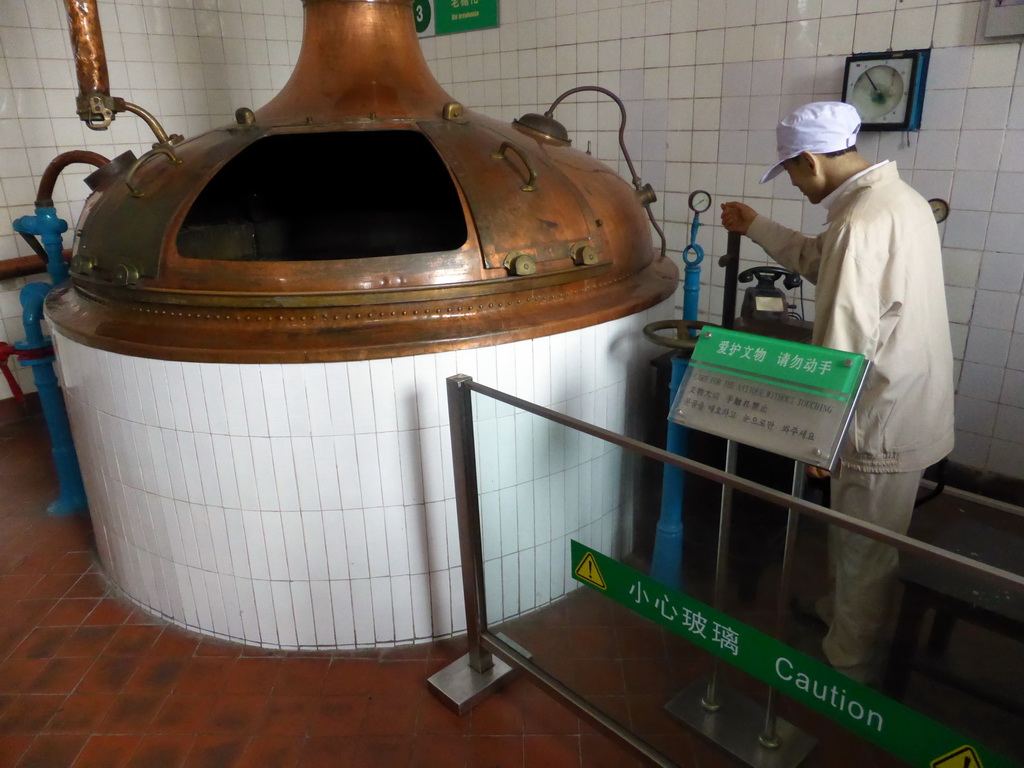 Brew kettle and a wax statue, at the Tsingtao Beer Museum