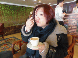 Miaomiao having a coffee in the lobby of the Oceanwide Elite Hotel
