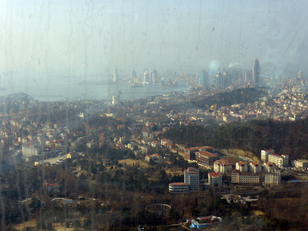 The city center, Xiao Qingdao island and Zhan Qiao pier in Qingdao Bay and skyscrapers and dome at the west side of the city, viewed from the highest indoor level at the Qingdao TV Tower
