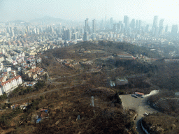 Qingdao Zongshan Park and the skyscrapers and World Trade Center buildings at the east side of the city, viewed from the highest indoor level at the Qingdao TV Tower