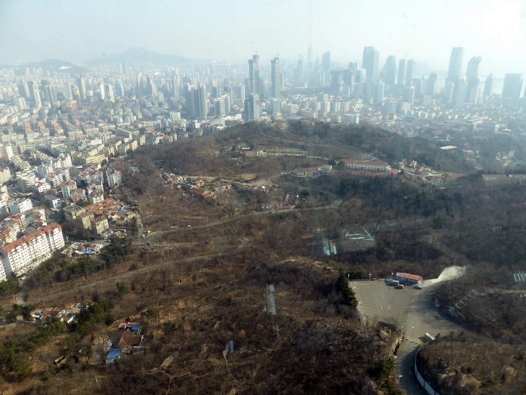 Qingdao Zongshan Park and the skyscrapers and World Trade Center buildings at the east side of the city, viewed from the highest indoor level at the Qingdao TV Tower