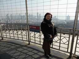 Miaomiao at the outdoor level at the Qingdao TV Tower, with a view on the Qingdao Zongshan Park and the skyscrapers and World Trade Center buildings at the east side of the city