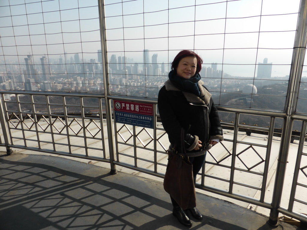 Miaomiao at the outdoor level at the Qingdao TV Tower, with a view on the Qingdao Zongshan Park and the skyscrapers and World Trade Center buildings at the east side of the city