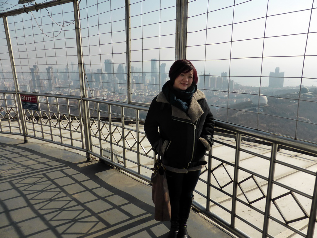 Miaomiao at the outdoor level at the Qingdao TV Tower, with a view on the skyscrapers at the east side of the city, the World Trade Center buildings, two domes at the Qingdao Zongshan Park, the Majesty Mansion at Donghai West Road and Fushan Bay