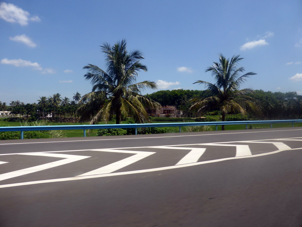 Houses along the road, viewed from the car on the G98 Hainan Ring Road Expressway