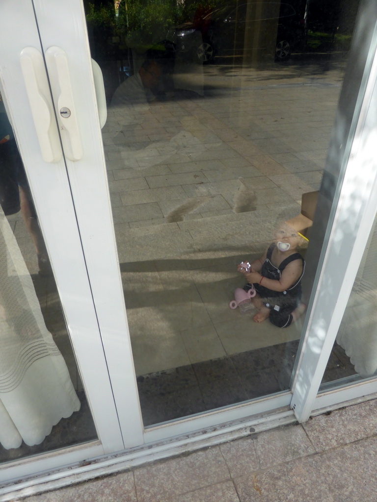 Max in the room of Miaomiao`s family at the Guantang Hot Spring Resort, viewed through the window