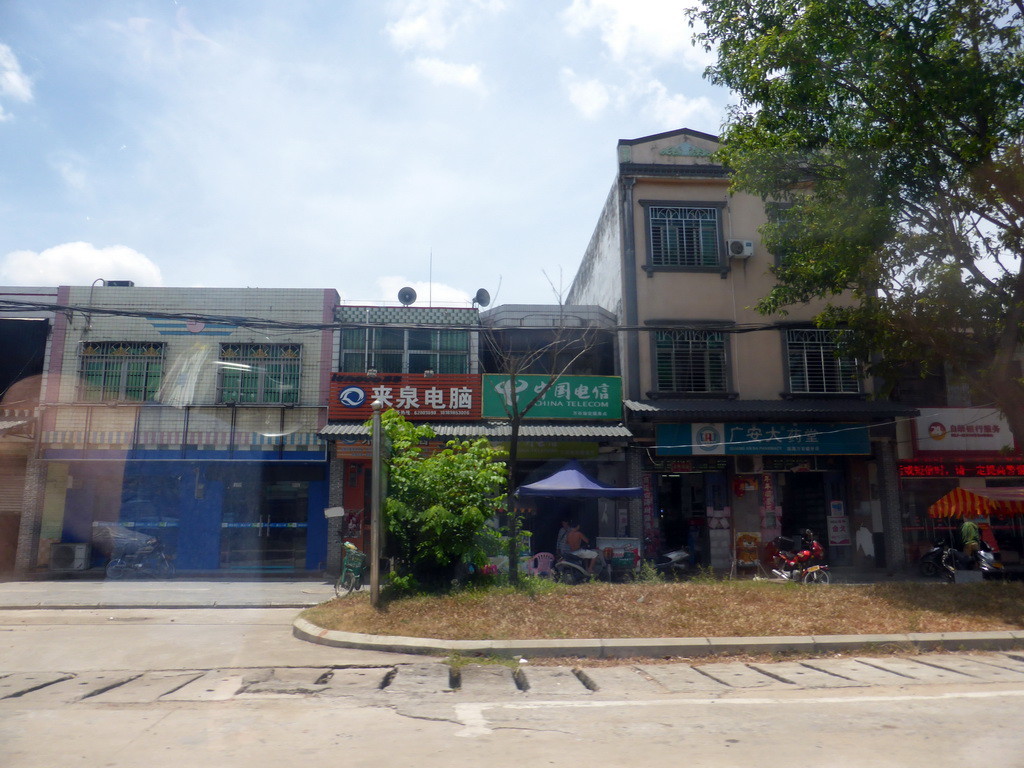 Shops in a street at the southwest side of the city, viewed from the car