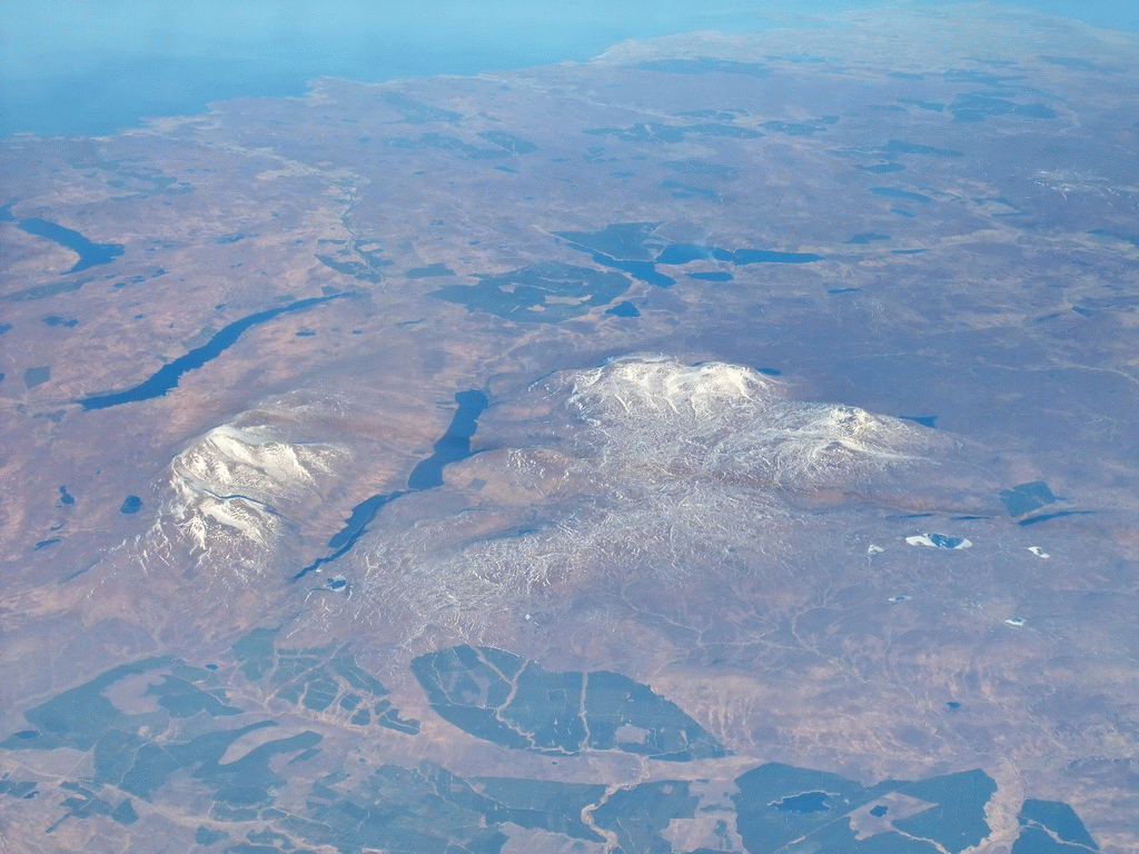 Lochs and mountains at the northwest coast of Scotland, viewed from the plane from Amsterdam