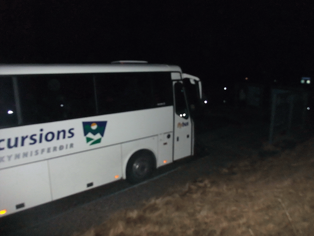 Our bus at a parking place during the Northern Lights Tour, by night