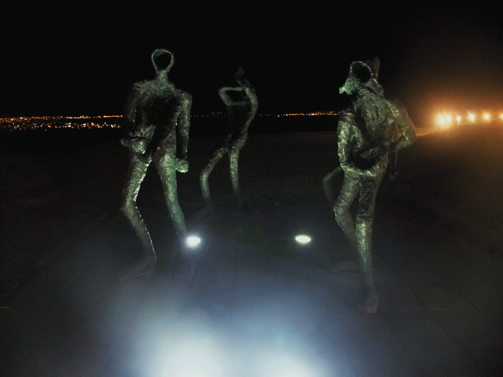 Sculptures `Dansleikur` by Torbjorg Palsdottir in front of the Perlan building, by night