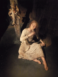 Wax statue of a woman eating fish, at the Saga Museum in the Perlan building