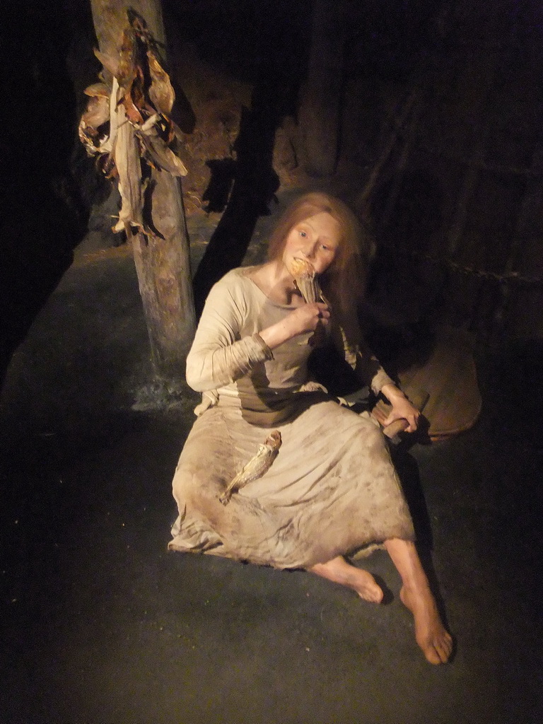 Wax statue of a woman eating fish, at the Saga Museum in the Perlan building