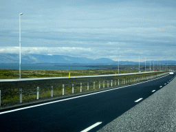 The Reykjanesbraut road, the Atlantic Ocean and mountains, viewed from the rental car