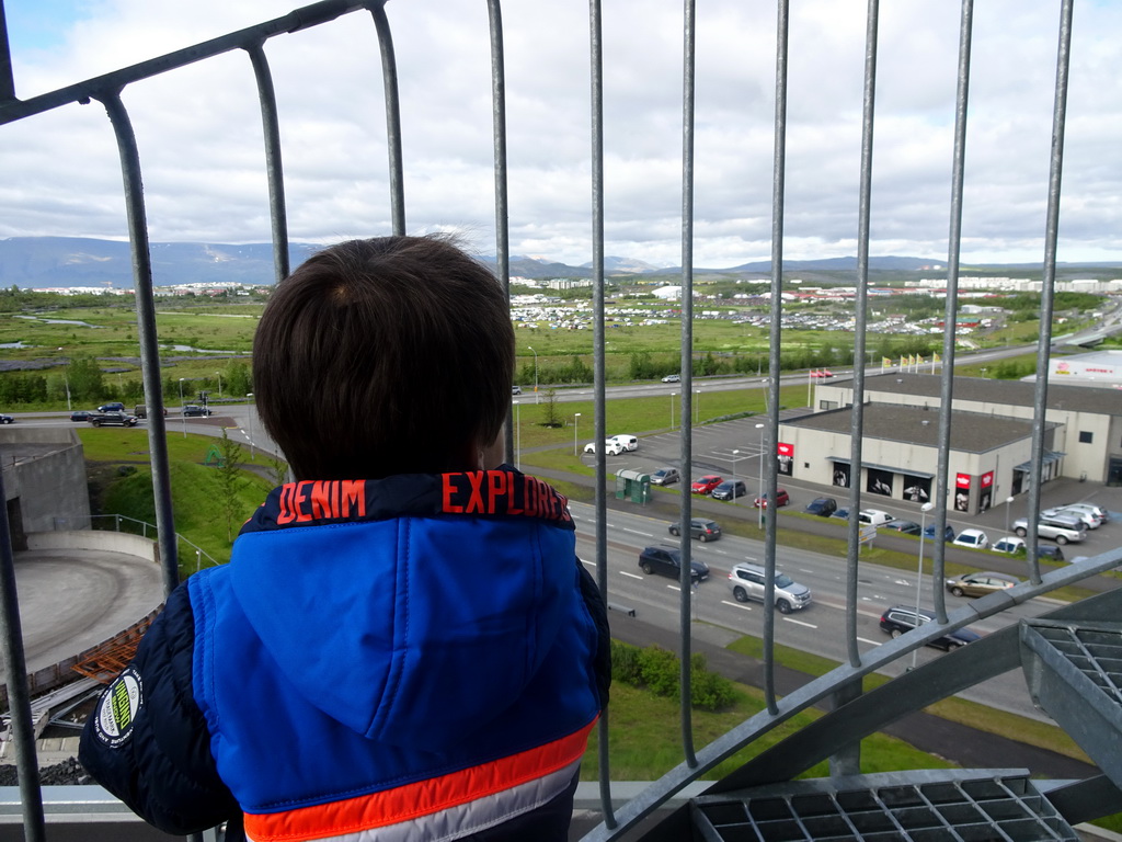 Max at the balcony of our apartment at the Icelandic Apartments, with a view on the east side of Kópavogur and mountains