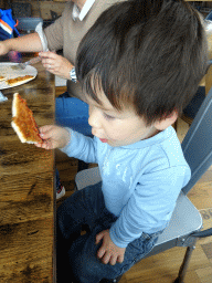 Max eating pizza at the Pure Deli restaurant at Kópavogur
