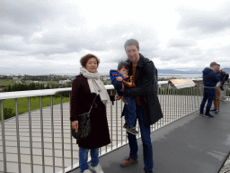 Tim, Miaomiao and Max on the roof of the Perlan building, with a view on the city center