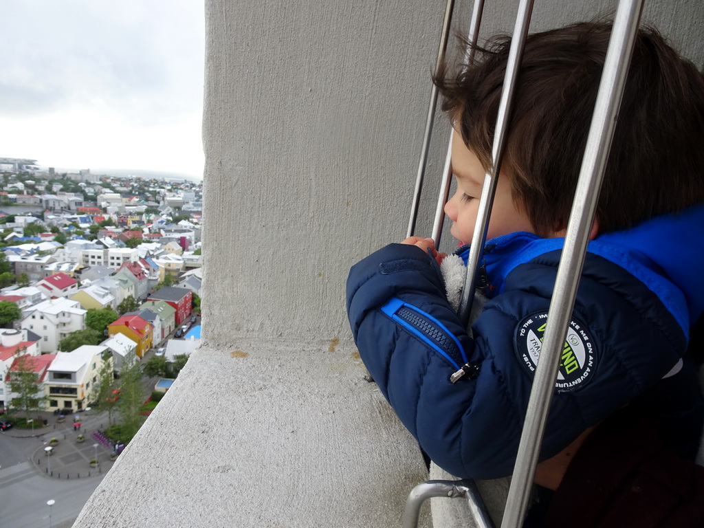 Max at the tower of the Hallgrímskirkja church, with a view on the northwest side of the city with Café Loki