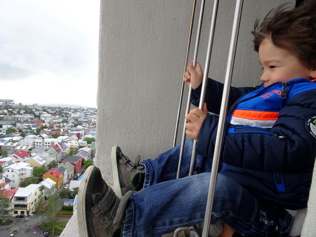 Max at the tower of the Hallgrímskirkja church, with a view on the northwest side of the city with Café Loki