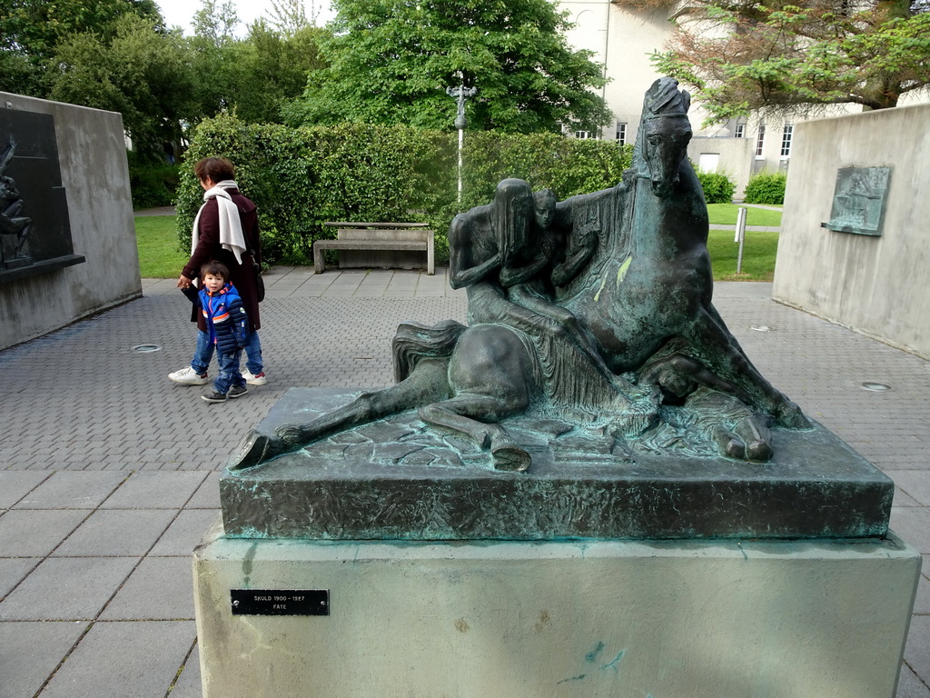 Miaomiao and Max with the sculpture `Fate` at the Einar Jónsson Sculpture Garden, with explanation